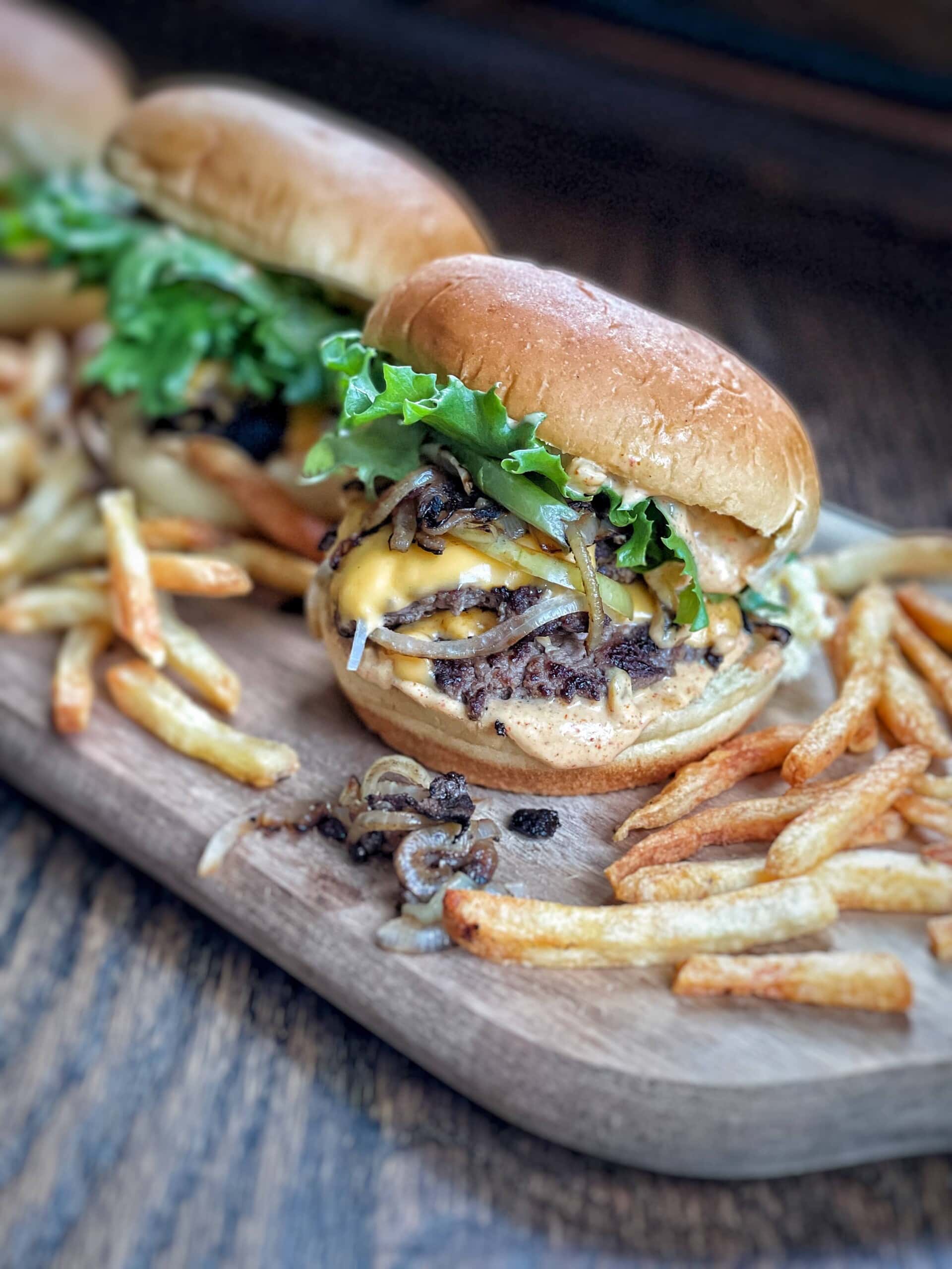 Cheesy Onion Smash Burgers - Over The Fire Cooking